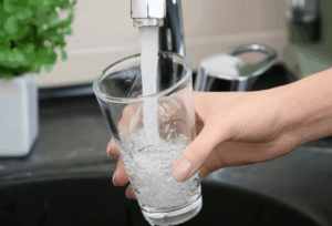 Clear water flowing from a faucet after professional well water filtration