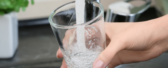 Clear water flowing from a faucet after professional well water filtration