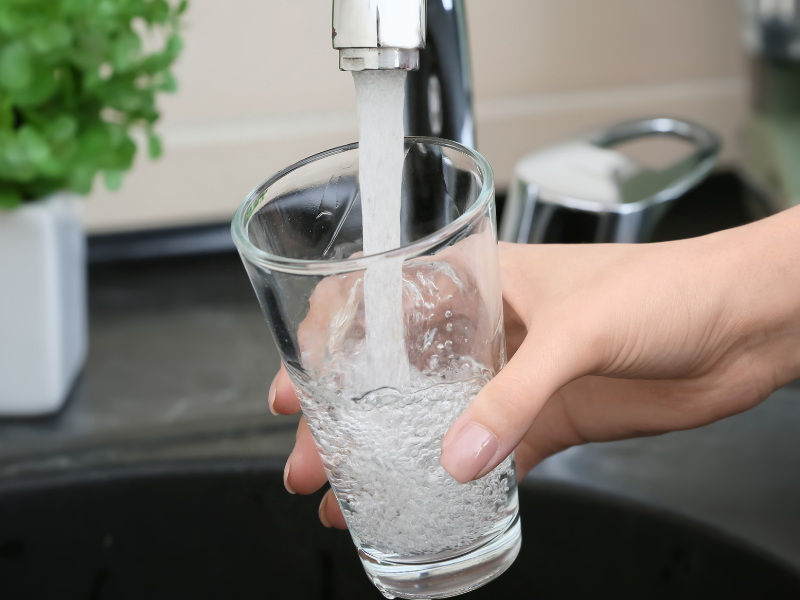 Clear water flowing from a faucet after professional well water filtration