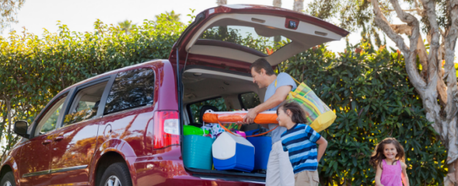 Family loading a vehicle for vacation before leaving home with a private well system.