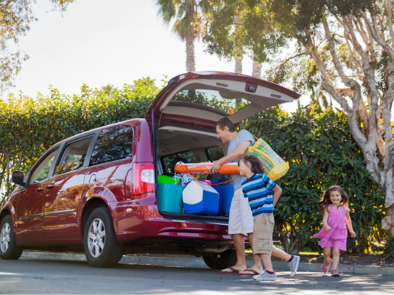 Family loading a vehicle for vacation before leaving home with a private well system.